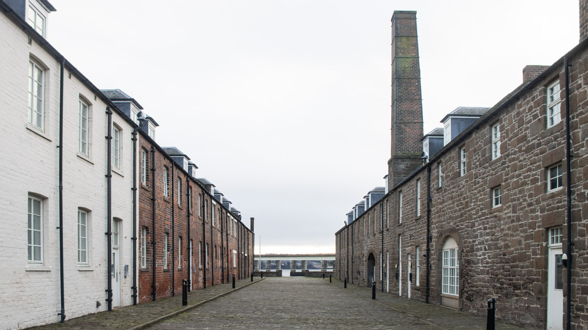 Historic street in Dundee on cloudy day.