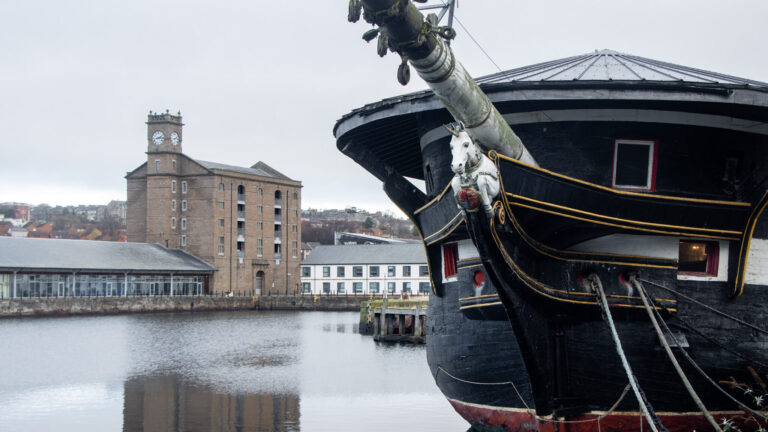 Historic ship with unicorn on the front.