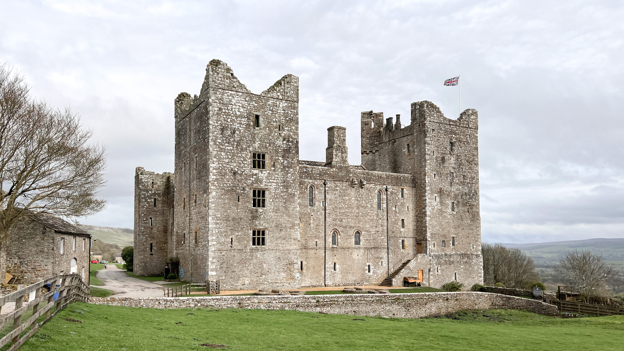 Small medieval castle surrounded by fields.