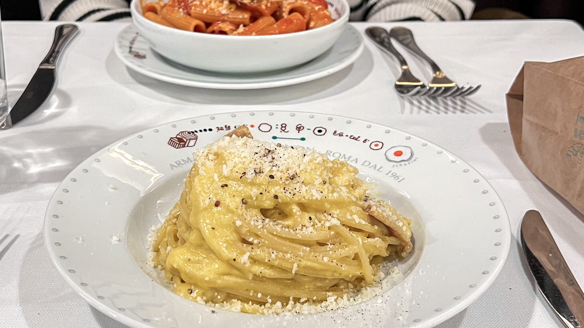 Two fresh dishes of pasta at restaurant in Rome.