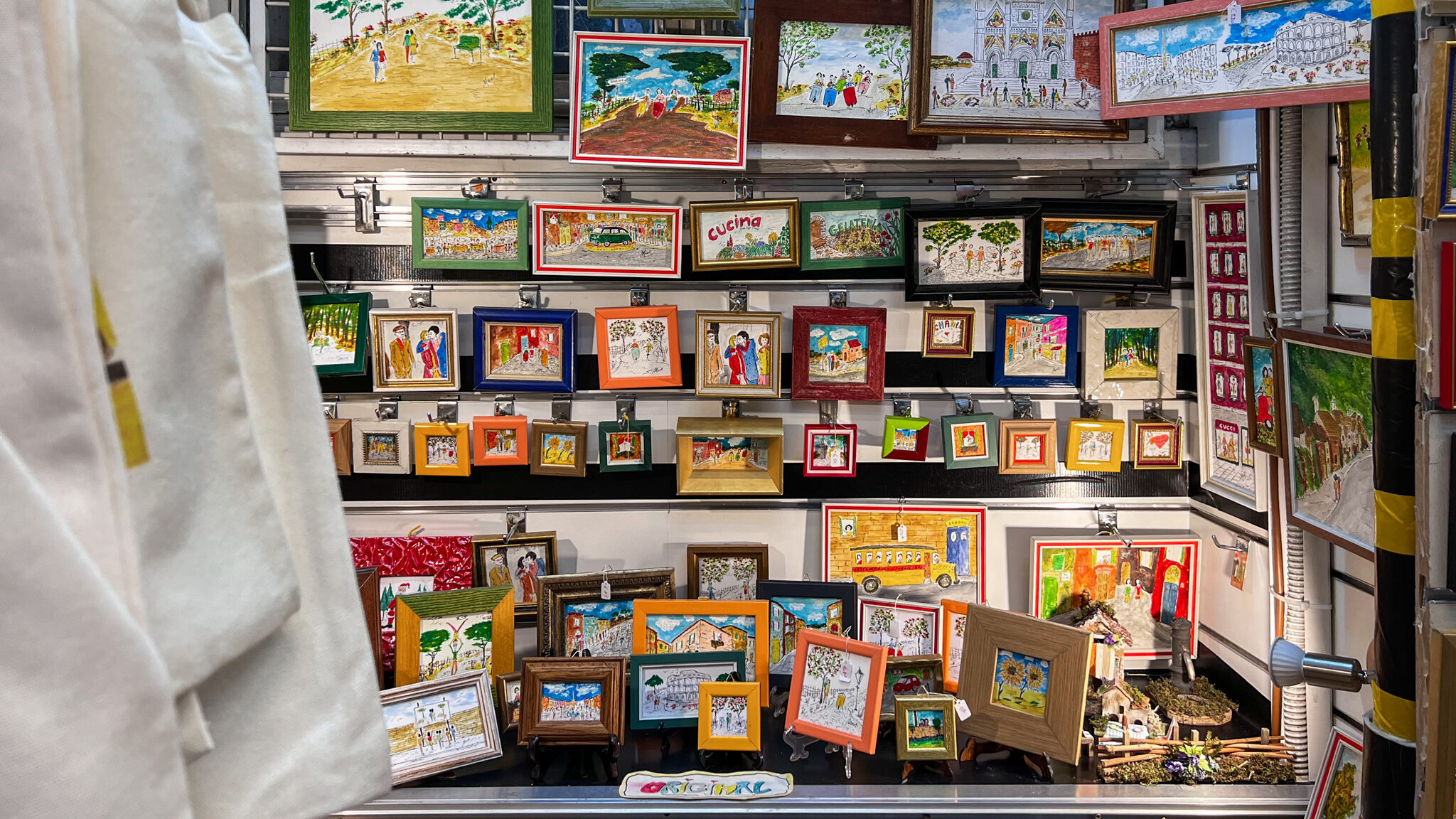 Wall filled with handmade prints in Rome.