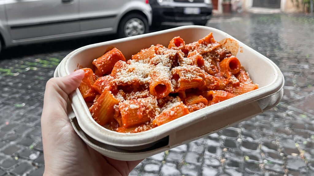 Al42 by Pasta Chef Rome | Krista the Explorer Tomato based rigatoni in takeaway container.