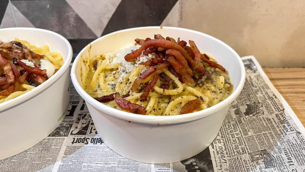 Pastaeat Rome | Krista the Explorer Paper bowl of carbonara with crispy guanciale Rome on a budget.