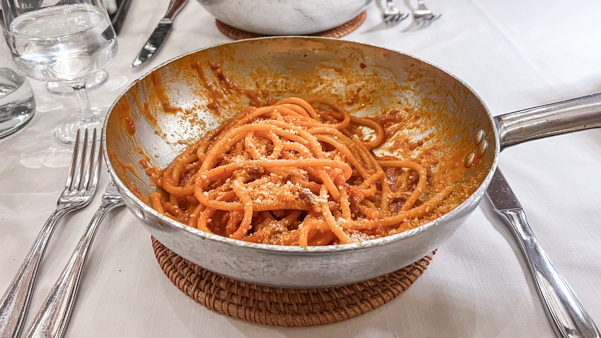 Fresh tomato-based pasta dish served in copper pan. 