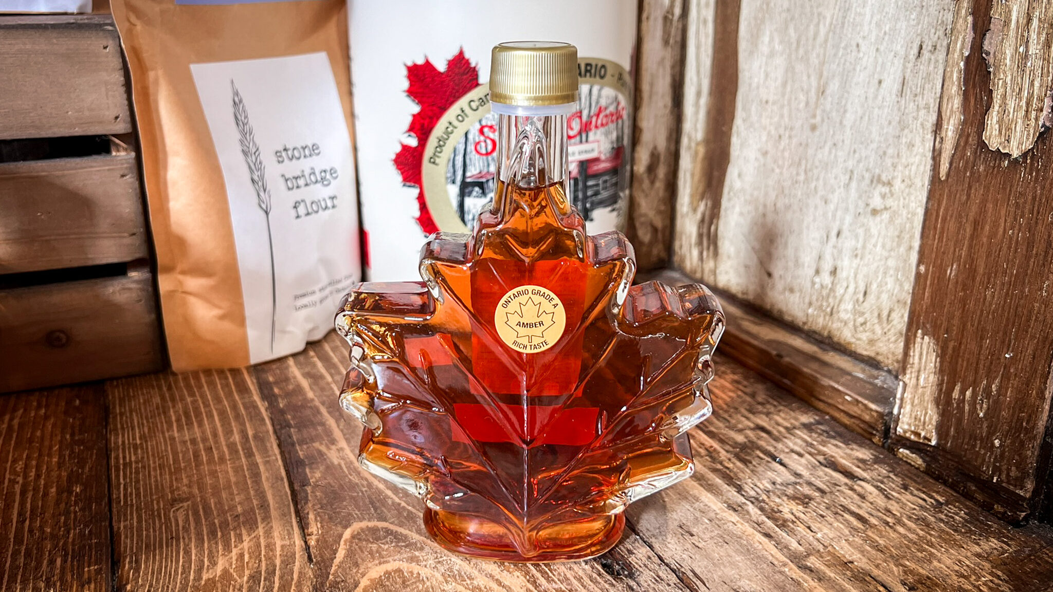 Maple Ontario | Krista the Explorer Glass bottle with maple syrup inside.