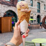 Waffle ice cream cone with two scoops inside.
