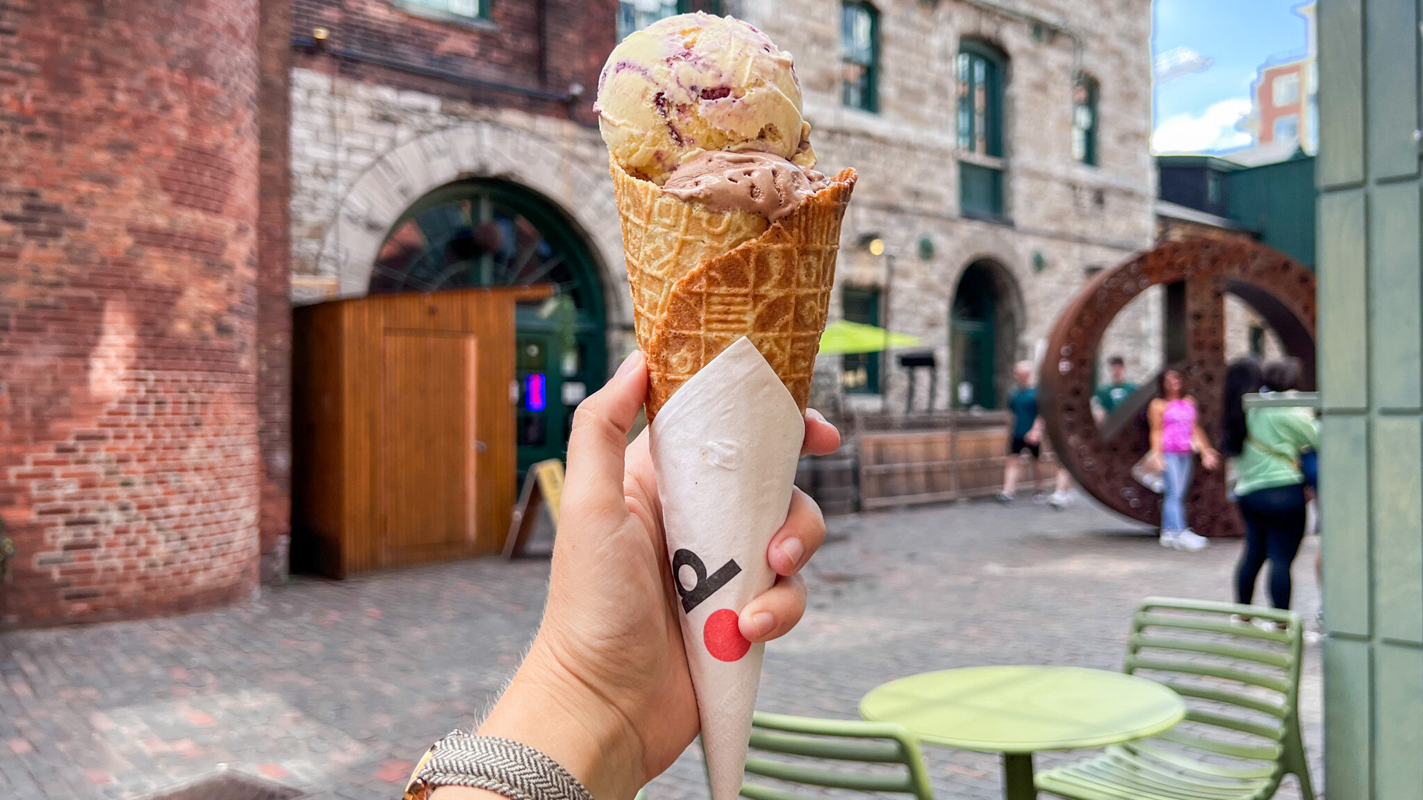 Waffle ice cream cone with two scoops inside.