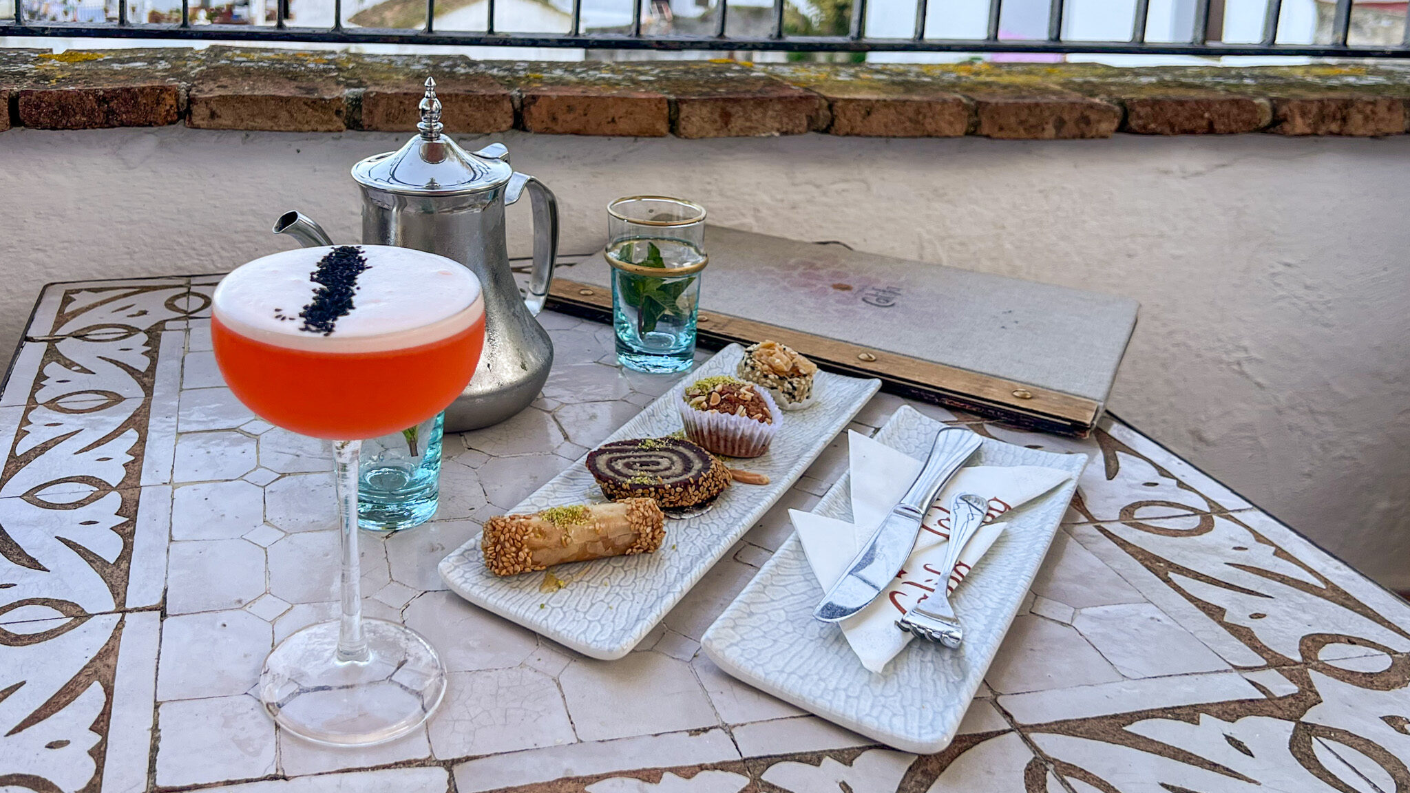 La Teteria del Califa Vejer | Krista the Explorer Various cocktails on table with Moroccan snacks.