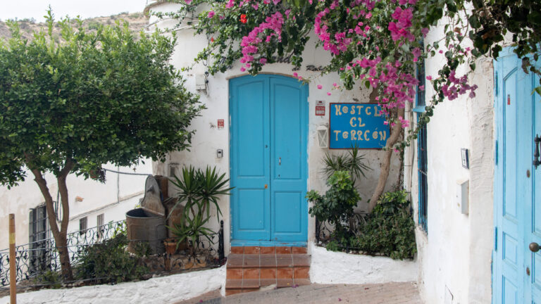 Blue door against white wall in Mojacar Pueblo.