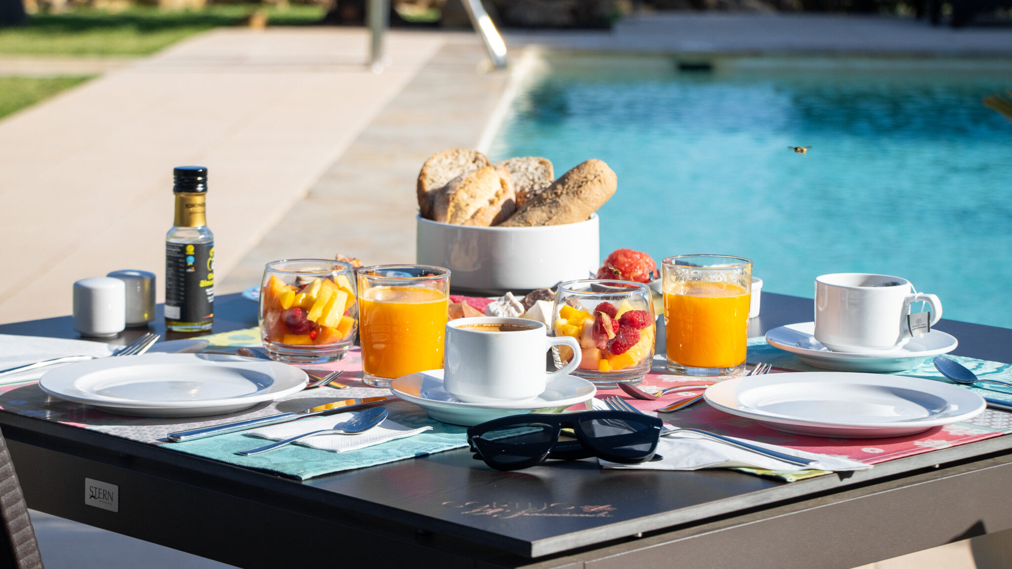 El Cortijo Mojacar | Krista the Explorer Continental breakfast set up on table next to pool.