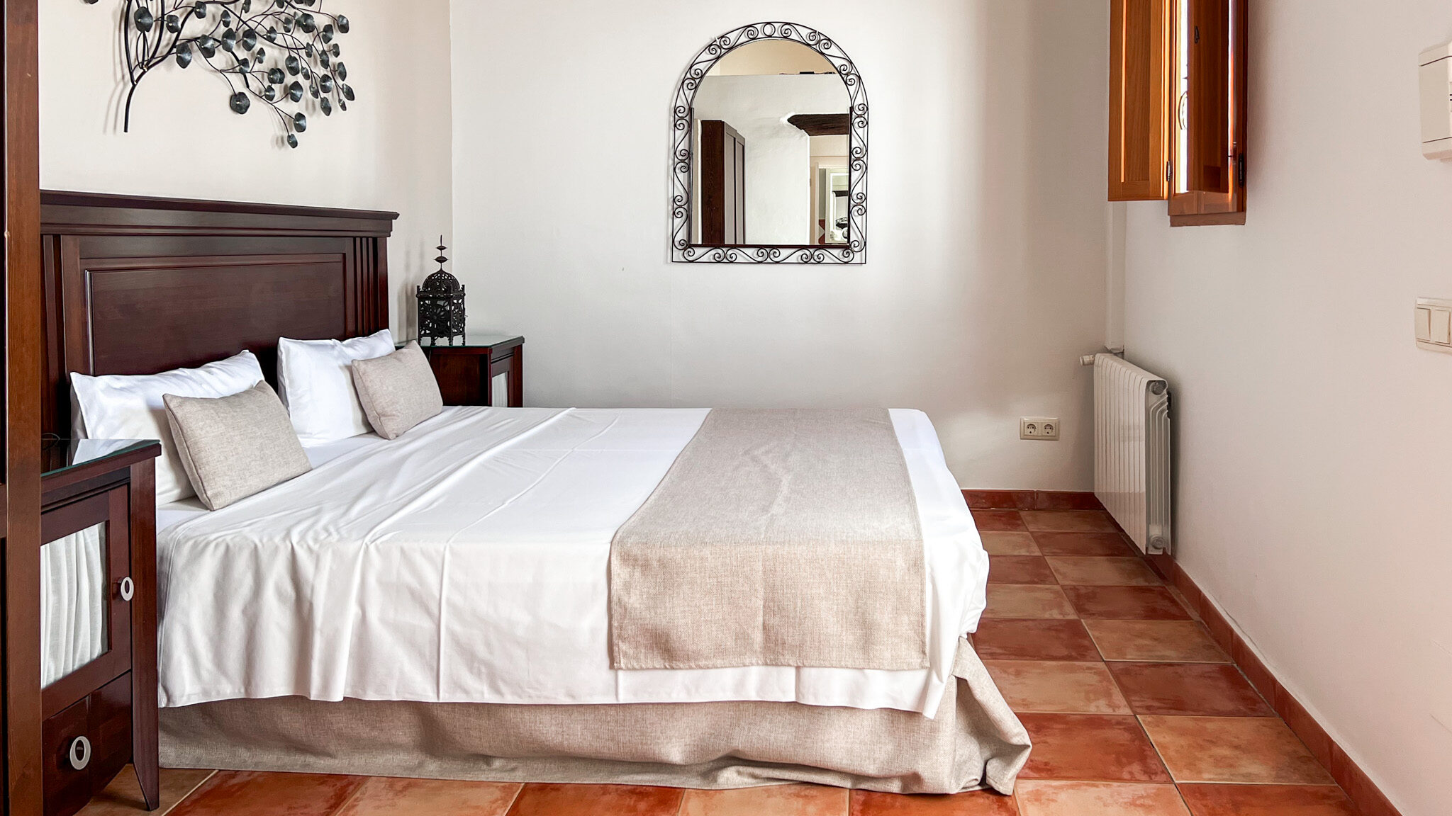El Cortijo Mojacar | Krista the Explorer Double bed in Andalusian-style room.