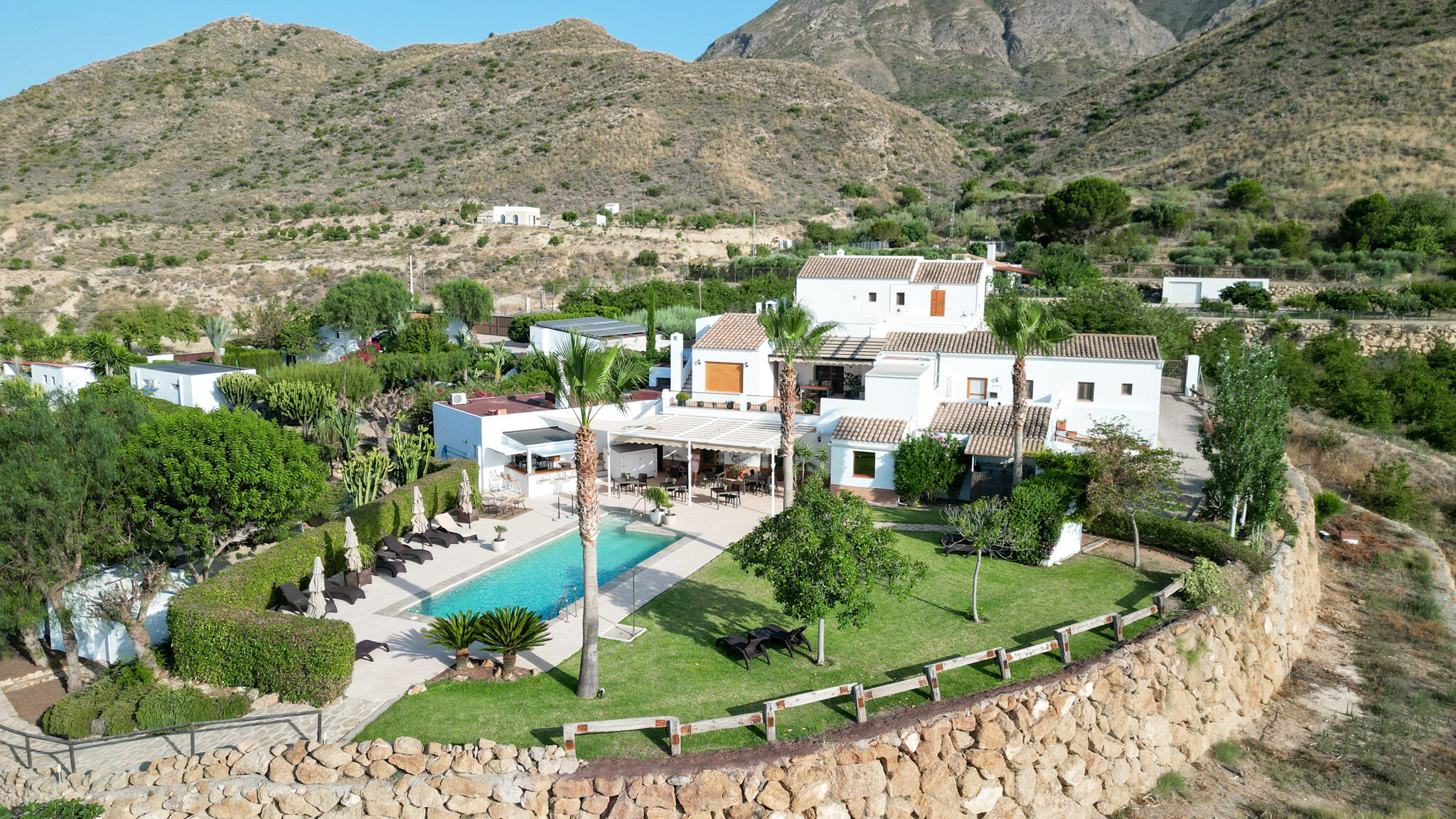 Aerial view of rural villa with a pool.