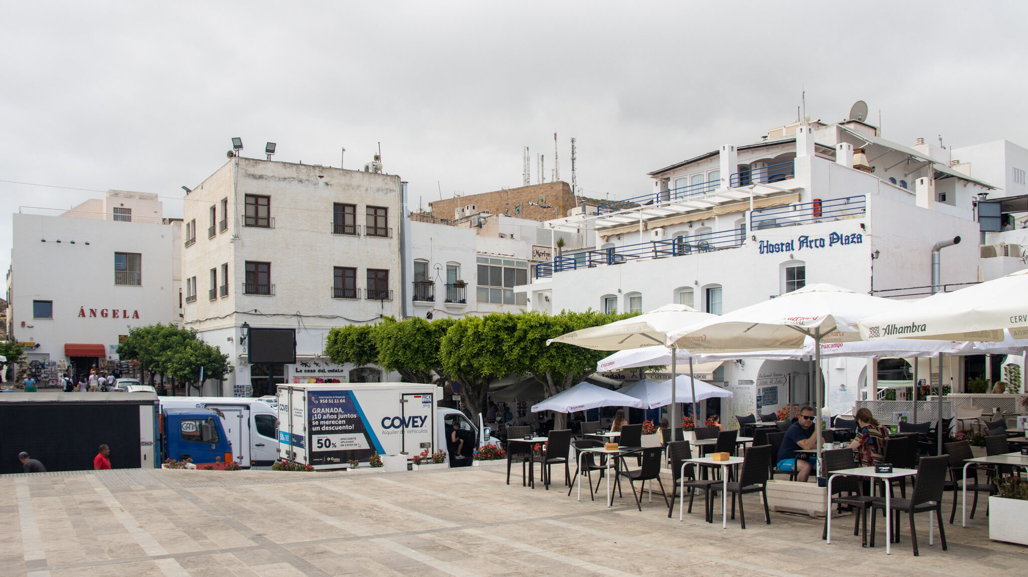 Small plaza with white buildings.