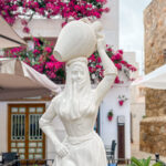 Statue of woman carrying olive pot.