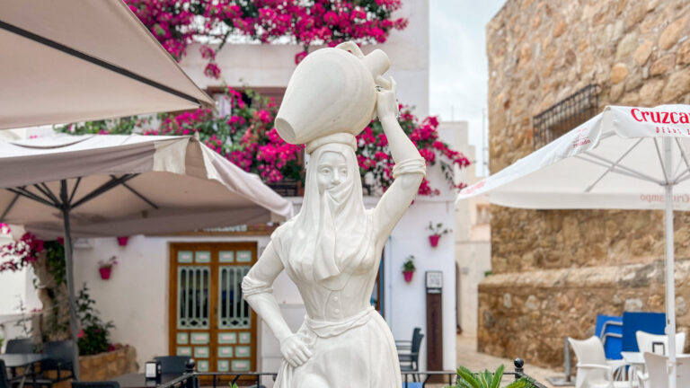 Statue of woman carrying olive pot.