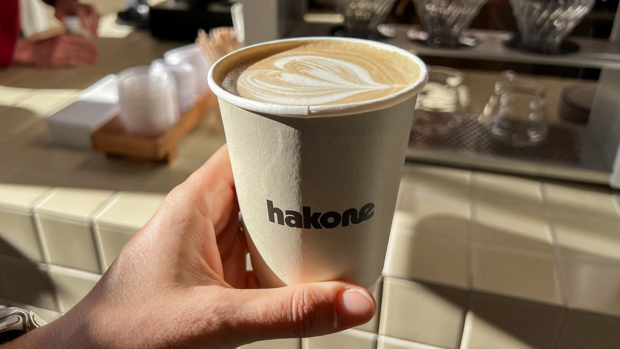 Hakone Coffee Oslo Weekend | Krista the Explorer Fresh latte in beige paper cup at cafe in Oslo.