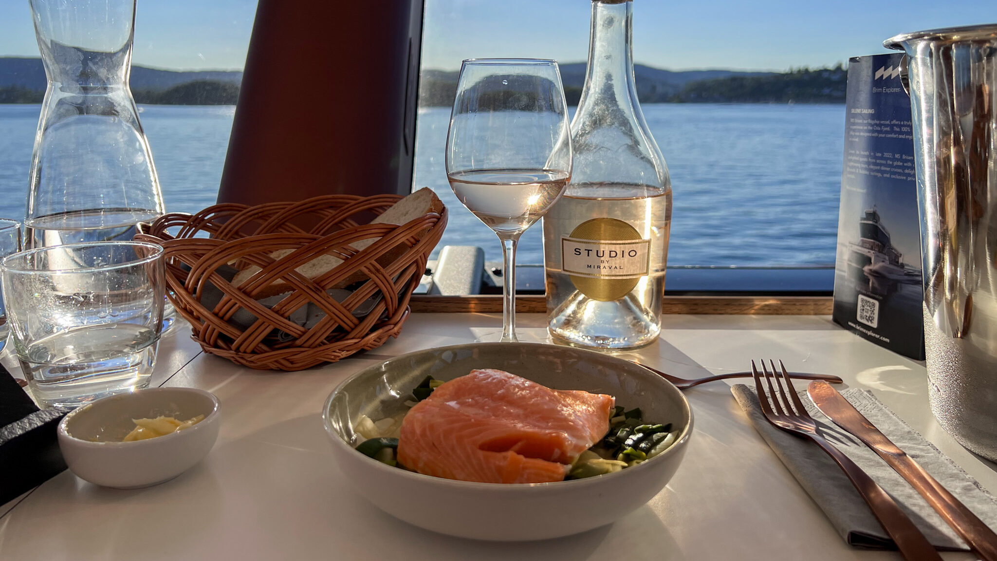 Dinner Cruise Oslo Weekend | Krista the Explorer Salmon dish on table with wine during dinner cruise.