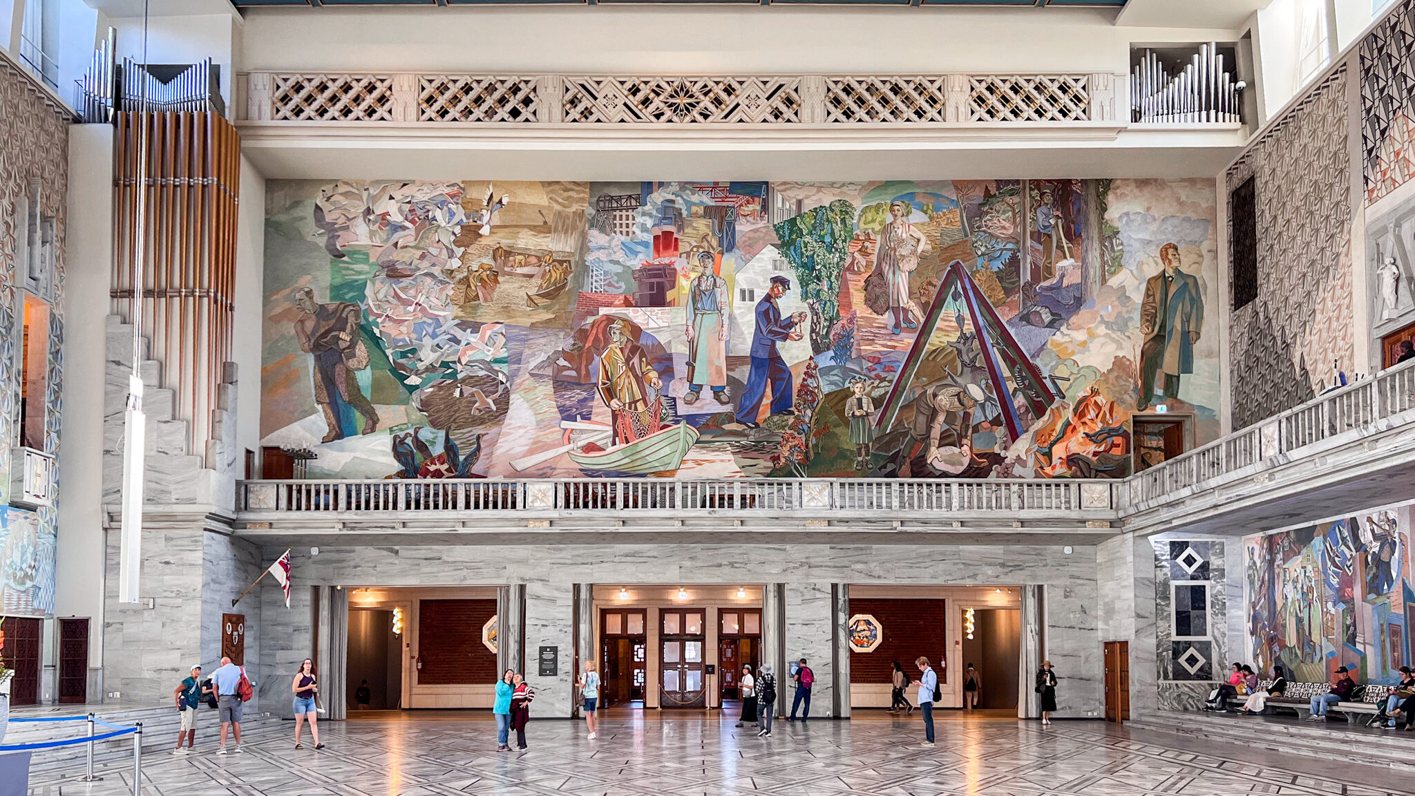 Oslo City Hall | Krista the Explorer Large space in city hall with murals on wall.