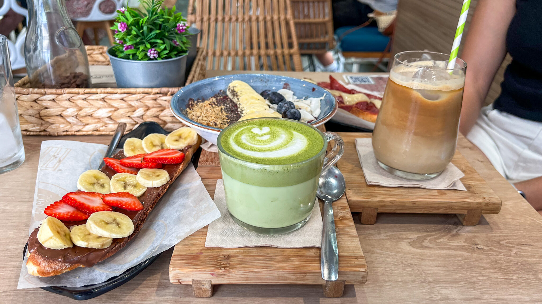 Selection of breakfast breads and coffees on table.