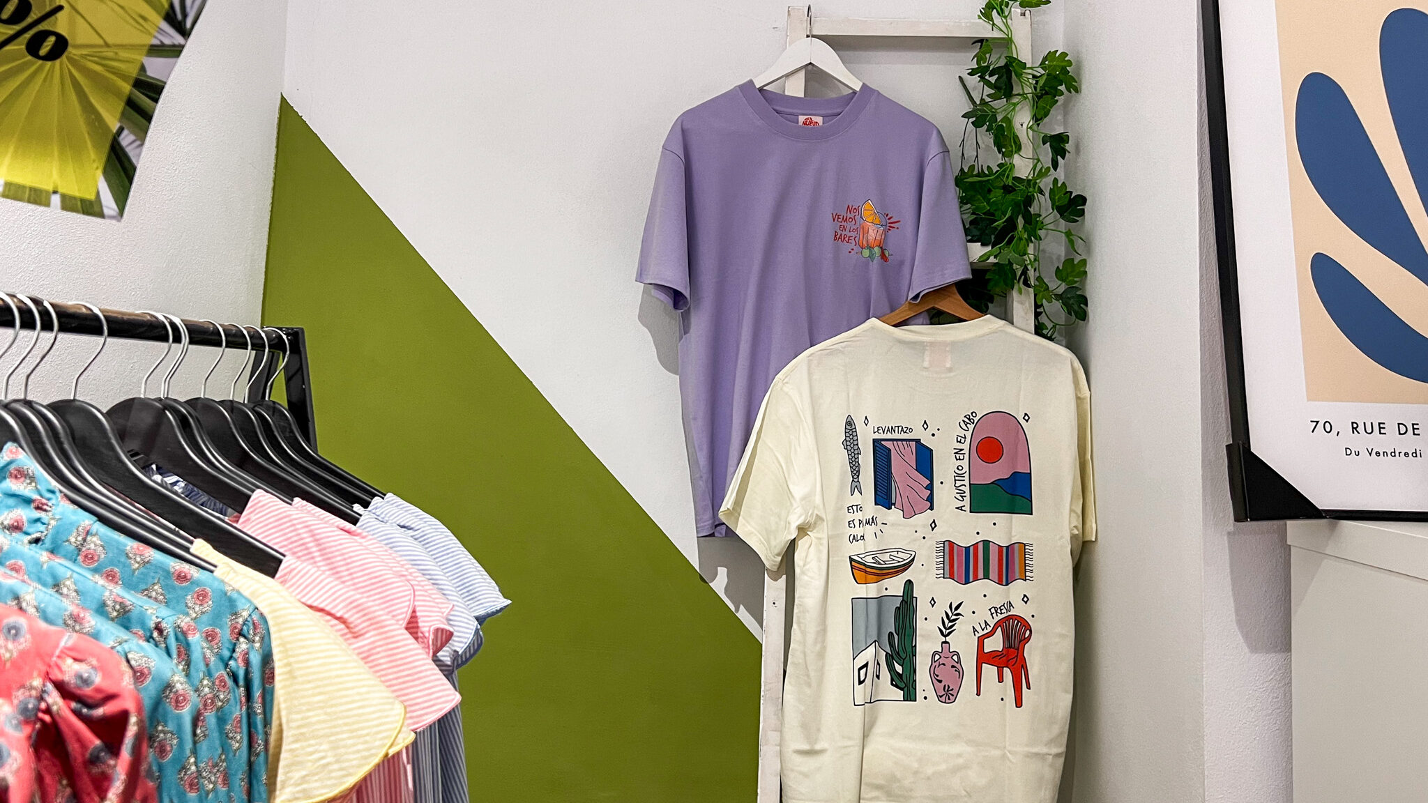 Artisan shop with t-shirts hung up on wall.