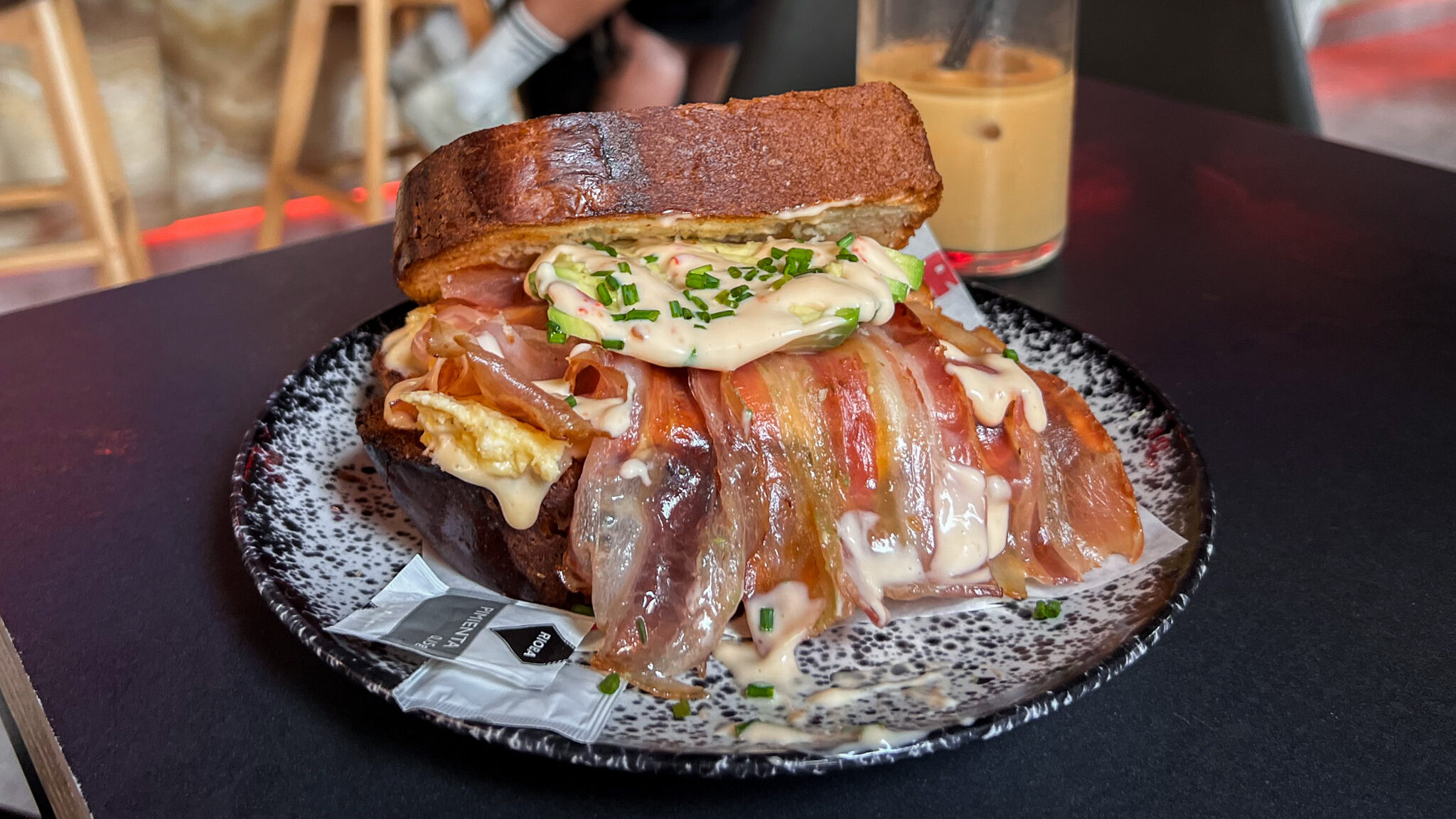 Brioche breakfast sandwich with bacon and eggs.