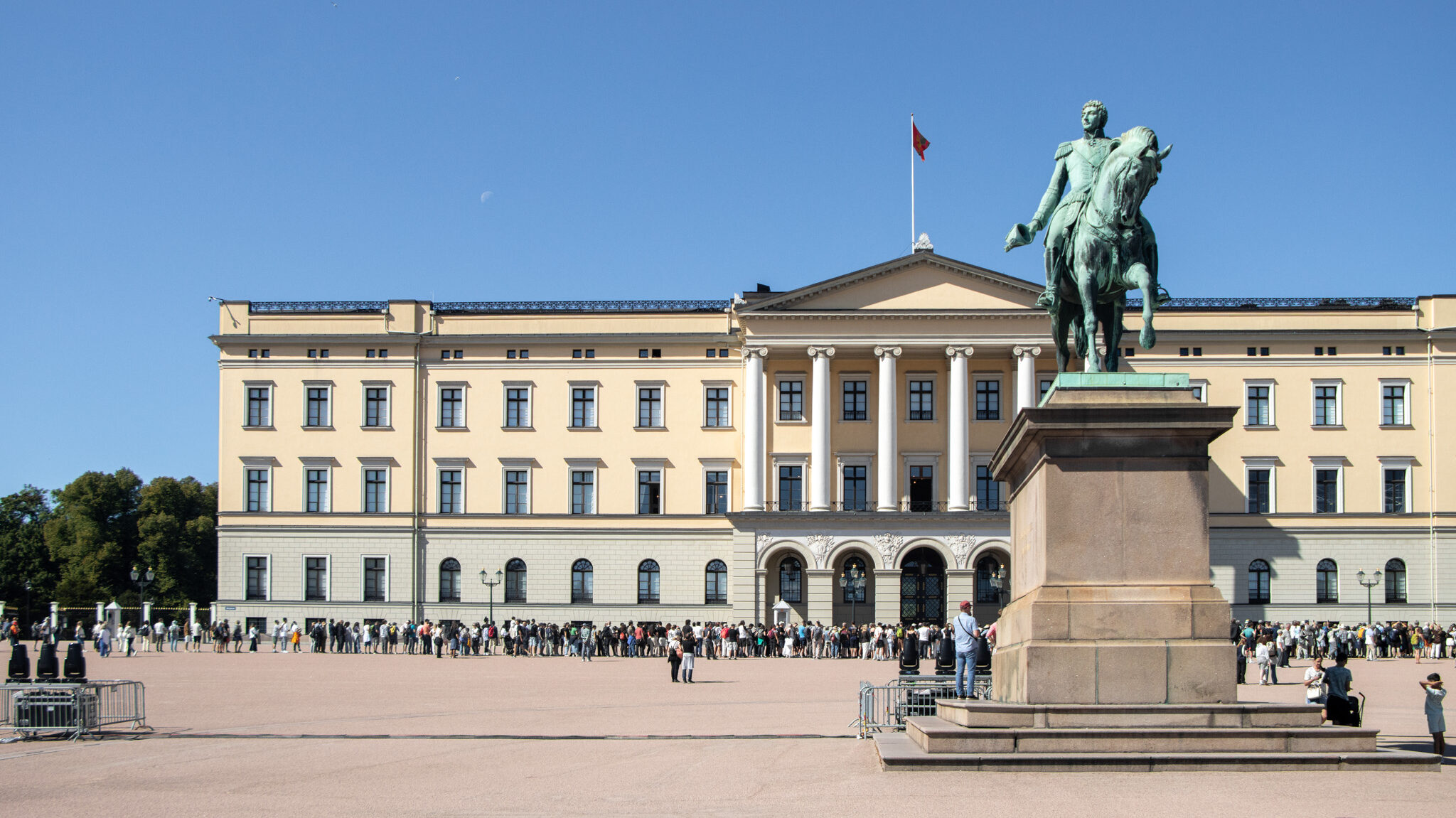 Royal Palace Oslo | Krista the Explorer Exterior of Royal Palace with statue of king in front.