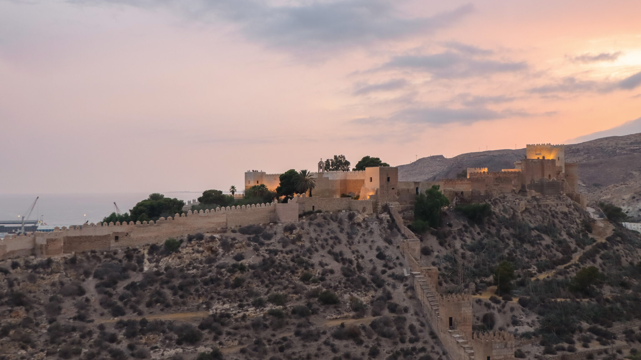 View of fortress from hilltop at sunset.