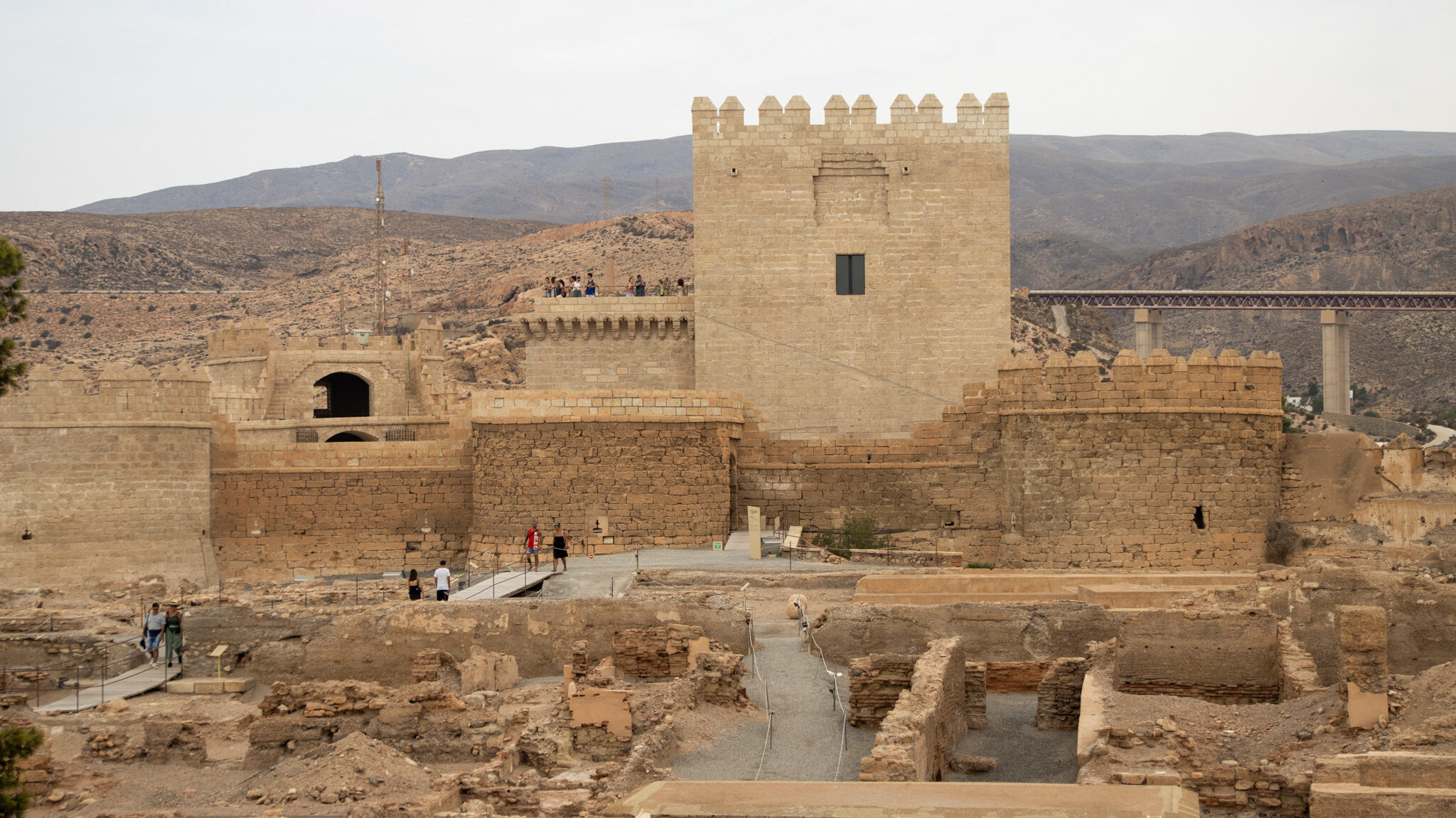 View of remains of medieval fortress on cloudy day.