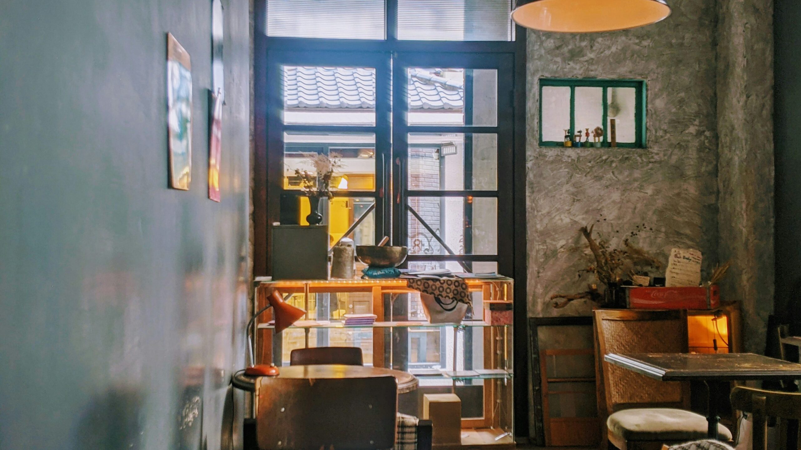 Nomad | Krista the Explorer Quiet cafe corner with warm lighting and no people.