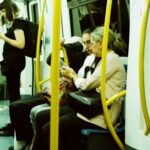 Passengers sitting on the London Underground.