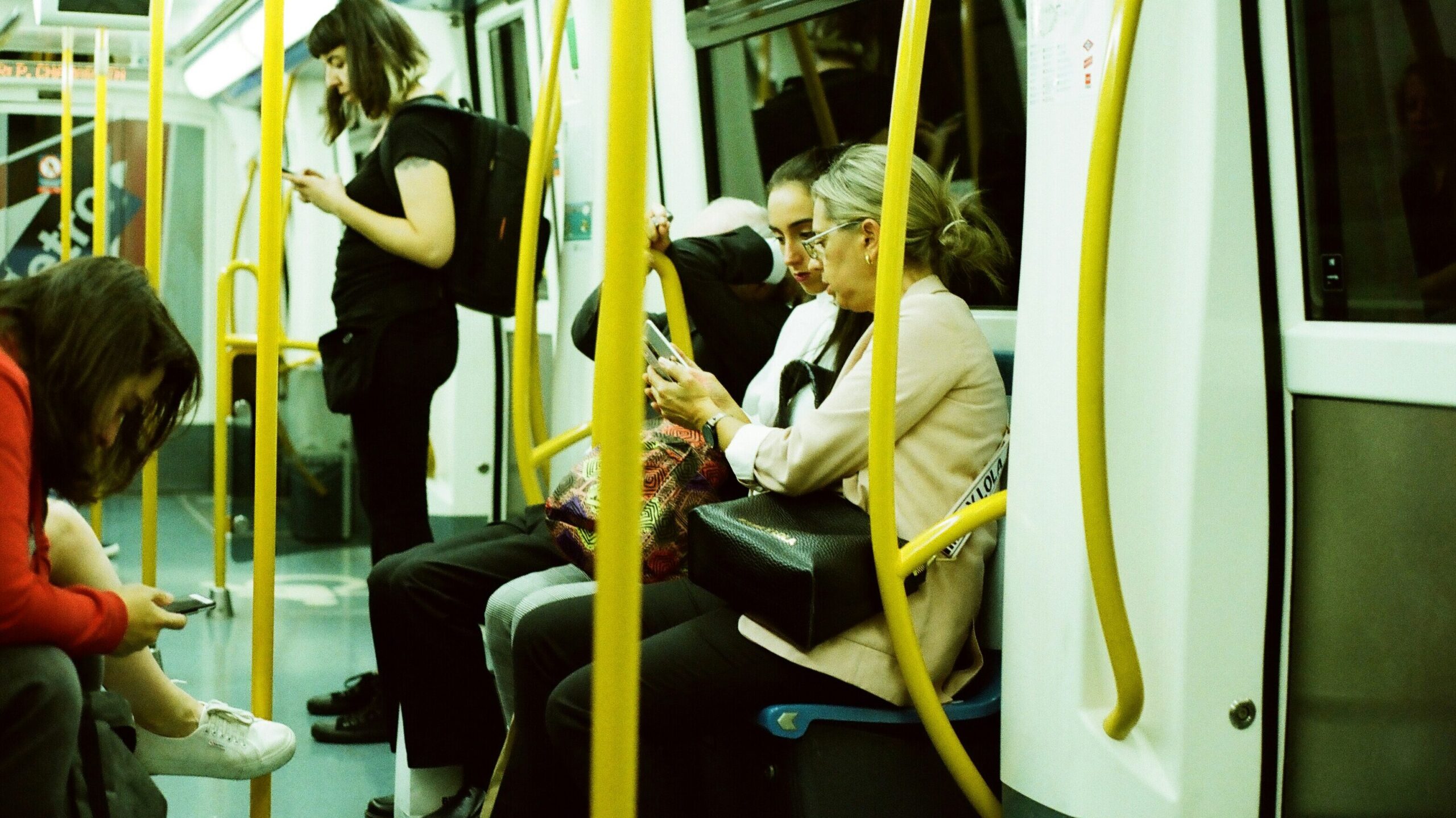 Passengers sitting on the London Underground.