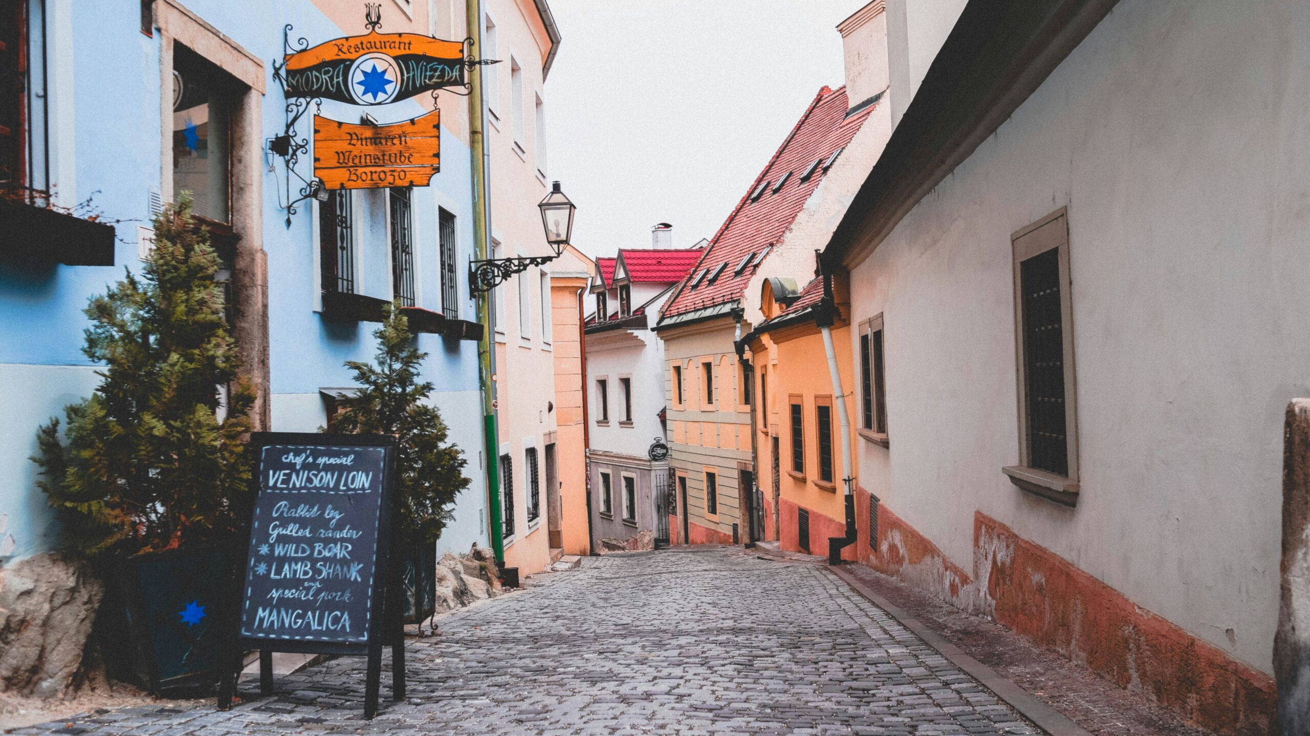 Nomad | Krista the Explorer Cobbled street in old town Bratislava with colourful houses.