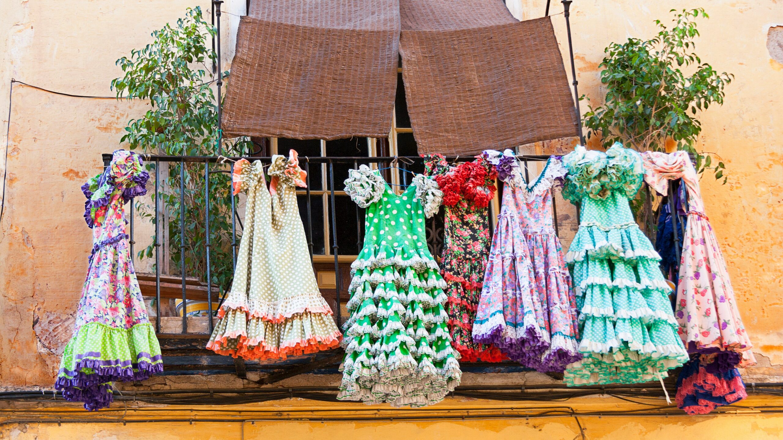 Nomad | Krista the Explorer Variety of flamenco dresses hung up outside apartment drying.