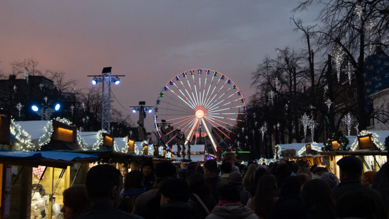 Christmas market with Ferris wheel at night.