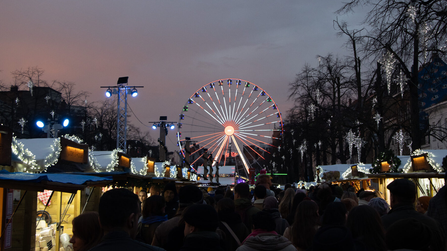 Christmas market with Ferris wheel at night.