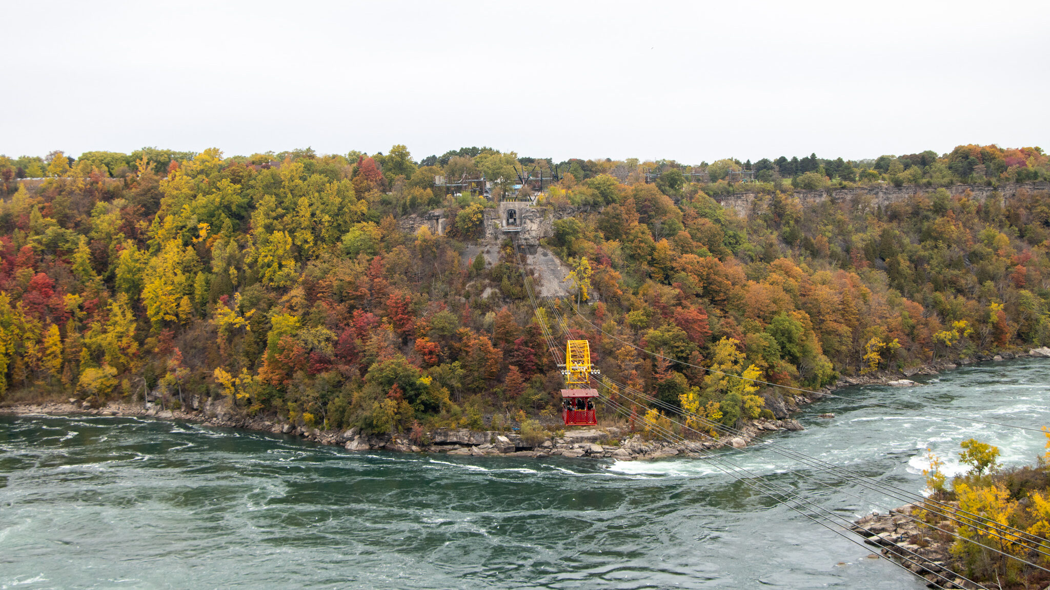 Whirlpool Aero Car Niagara Falls | Krista the Explorer View of a red vintage aero car going across Niagara River.