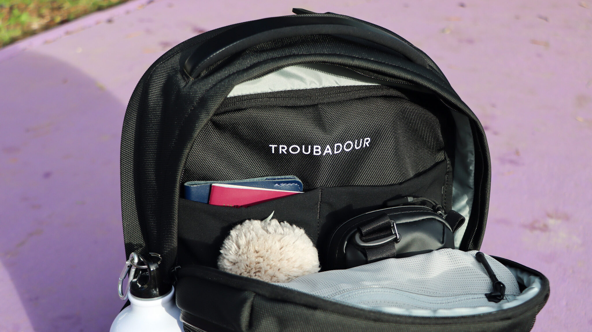 Troubadour Backpacks | Krista the Explorer Interior of black backpack with items inside.