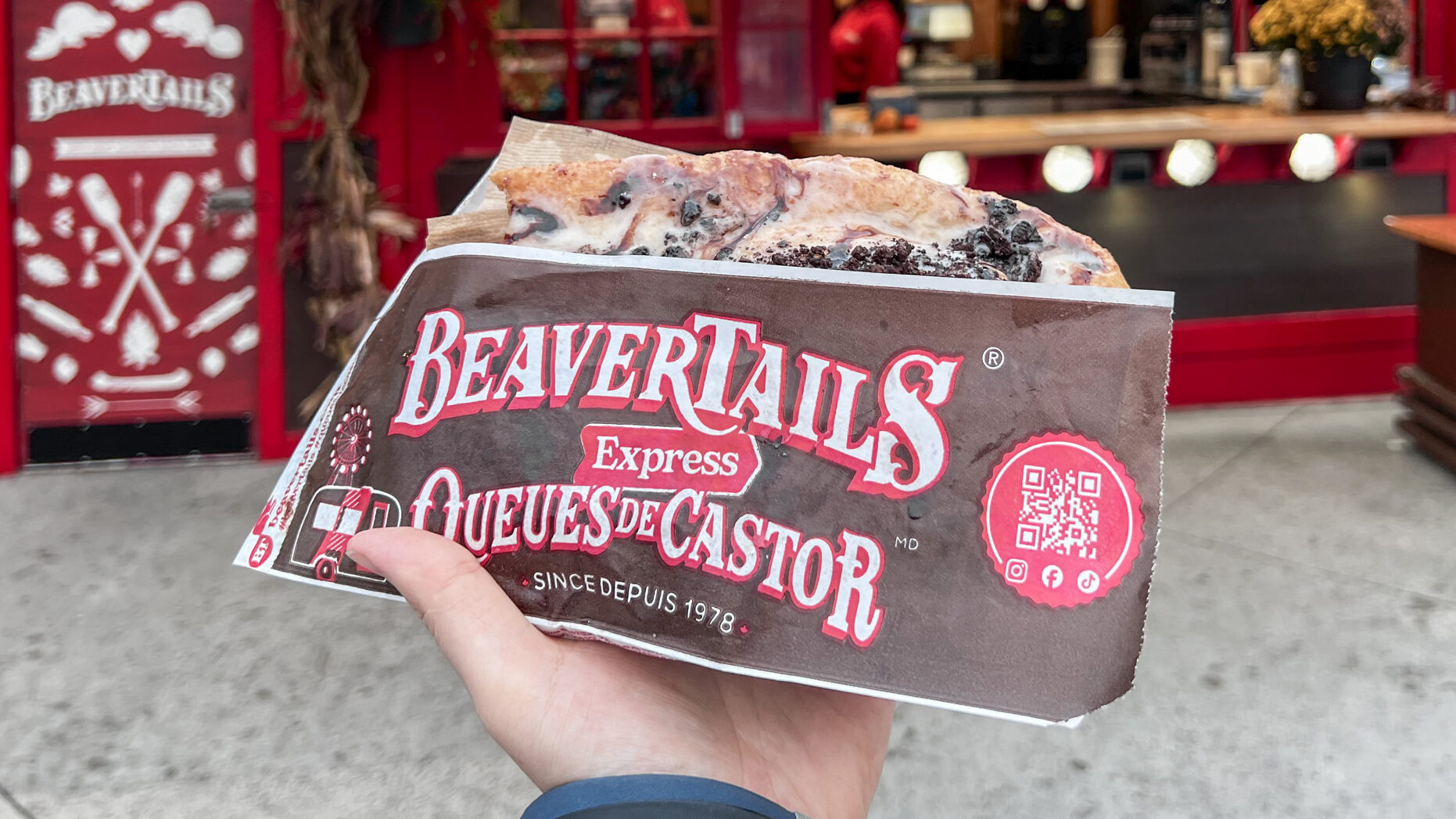 BeaverTails Ottawa | Krista the Explorer BeaverTail pastry in front of food stall in Ottawa.