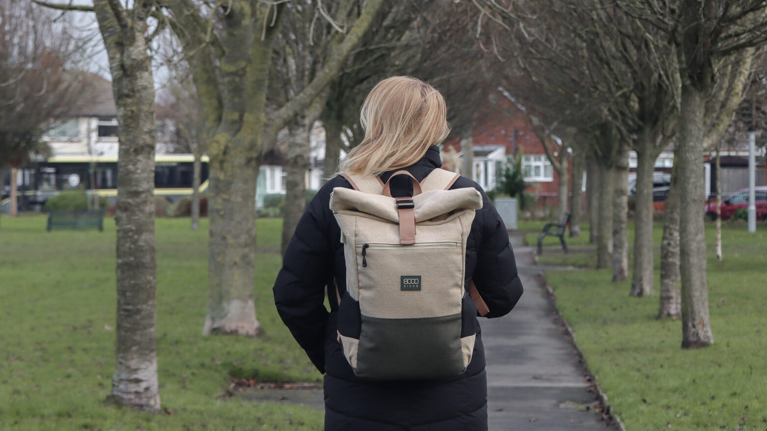 8000Kicks Backpacks | Krista the Explorer Person walking through park wearing hemp backpack.