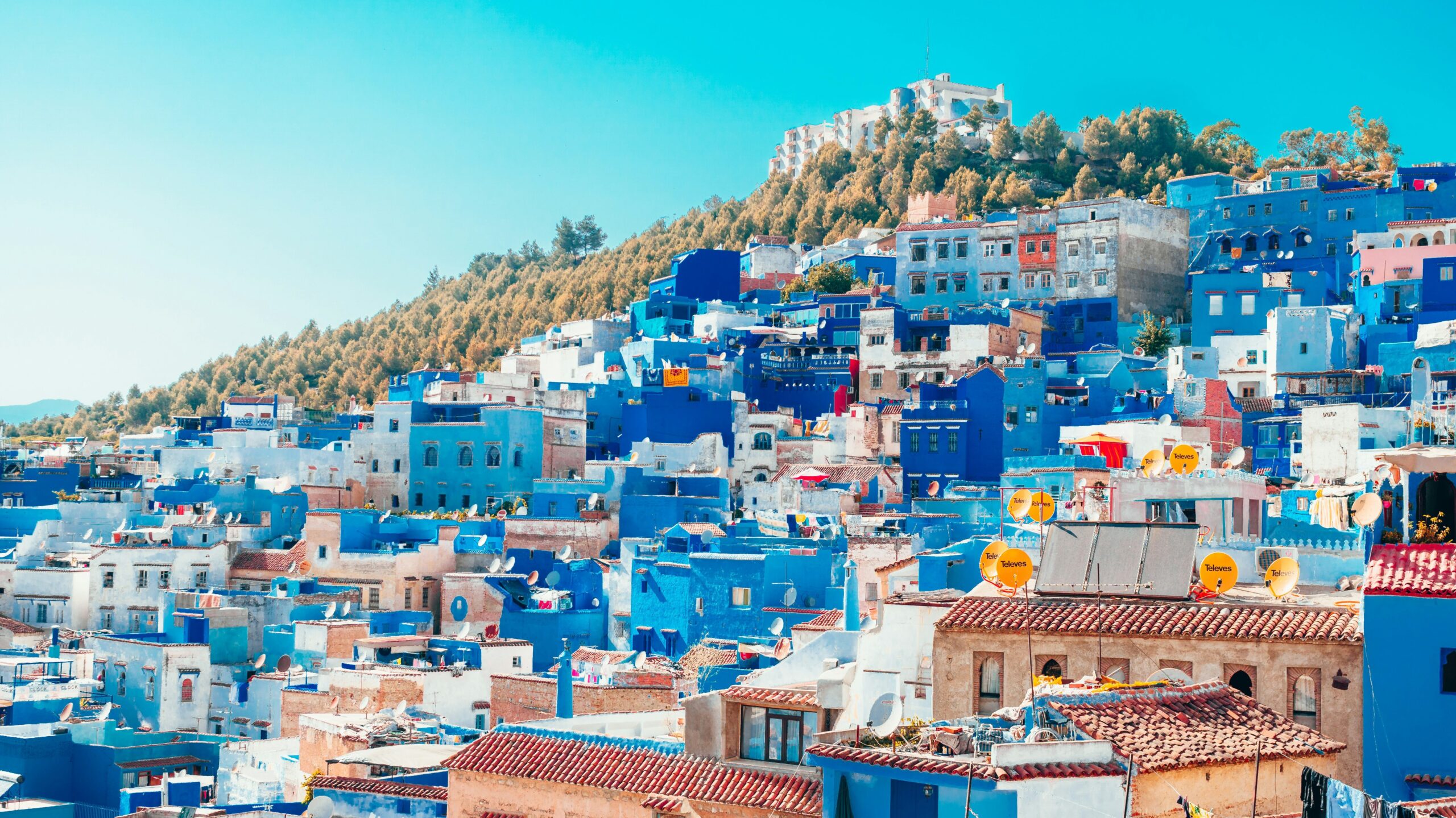 Morocco Study Abroad | Krista the Explorer Village on hill with white and blue houses.