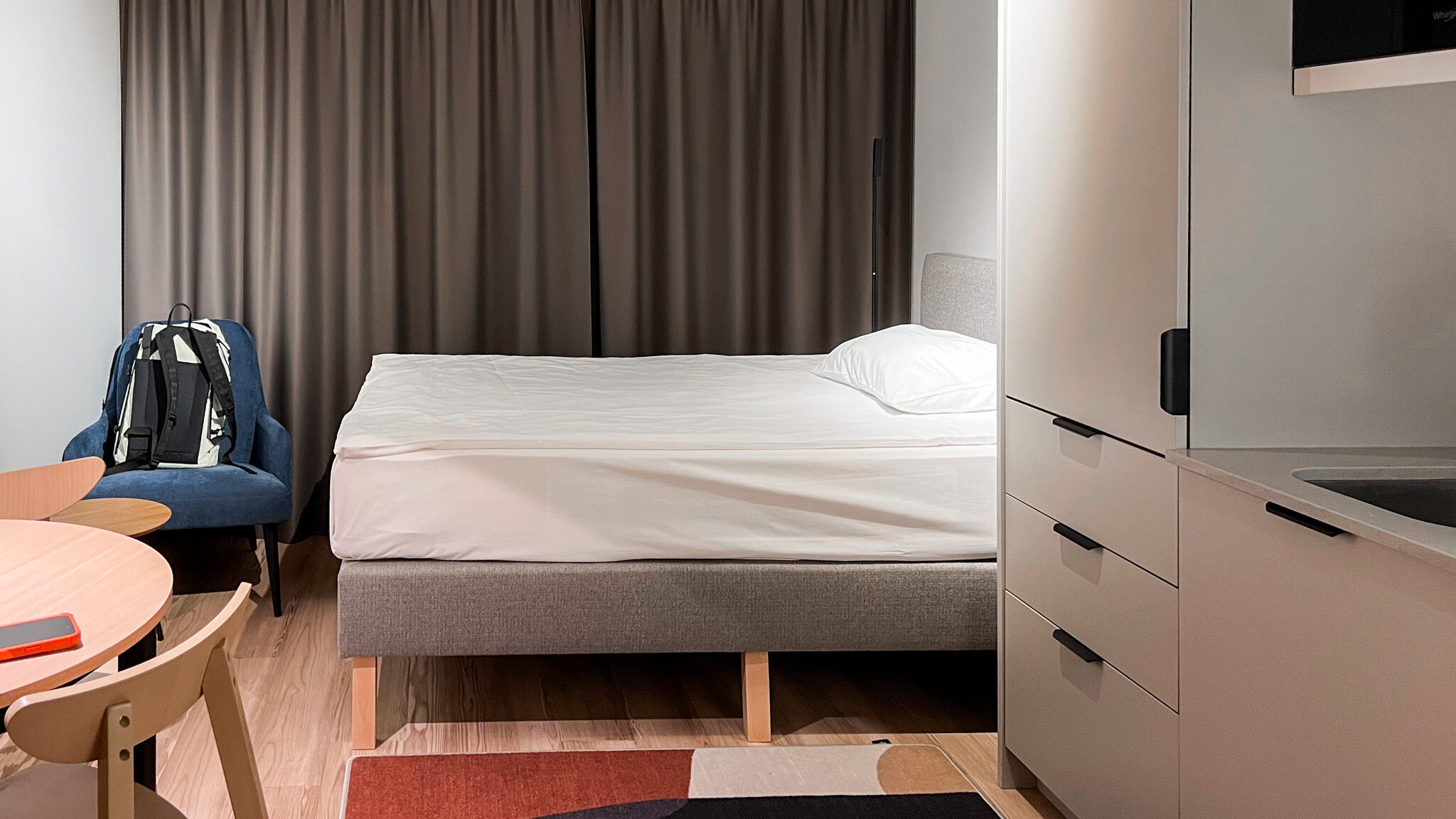 Studio room inside hotel in Poland with kitchen.