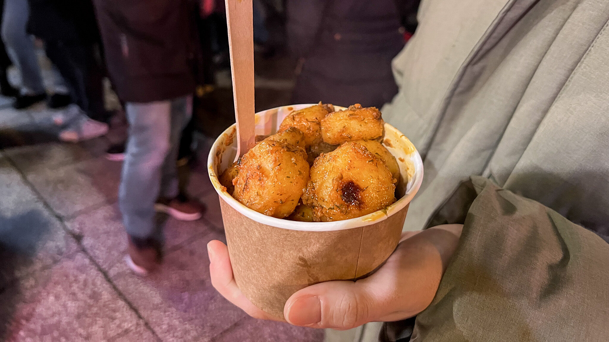 Cup of potatoes with orange seasoning.