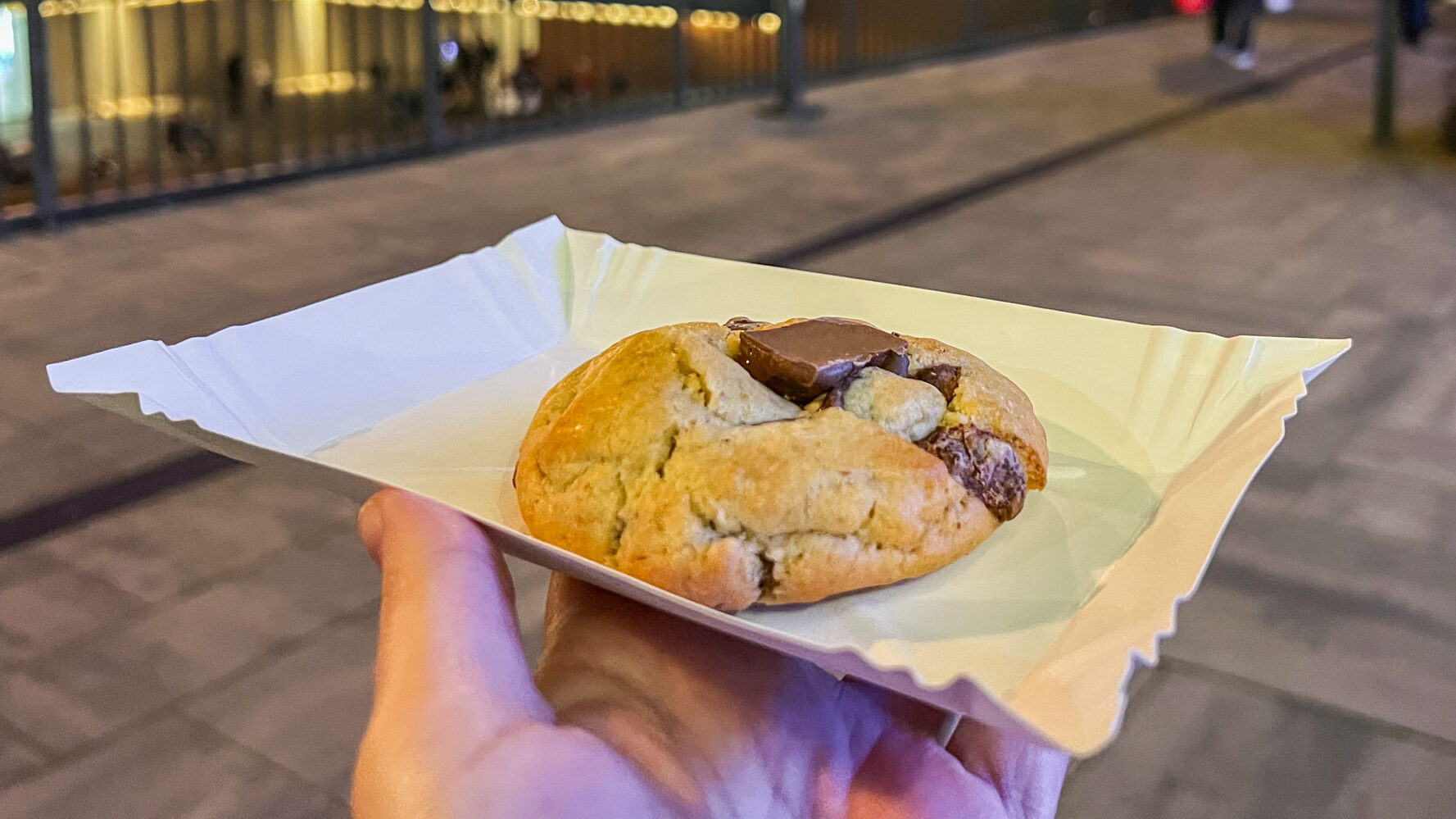 Stuffed chocolate chip cookie on paper plate.