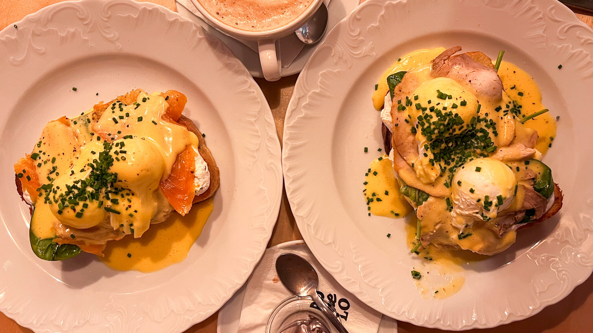 Two breakfast dishes with egg in restaurant.