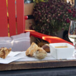 Wine and snacks served on outdoor patio.