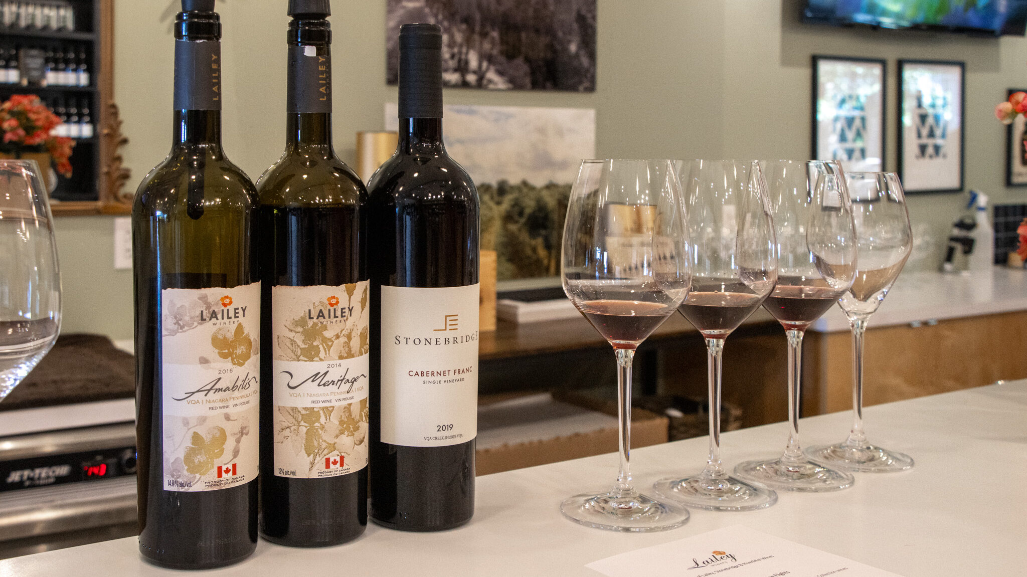 Lailey Winery | Krista the Explorer Three bottles of wine with sample glasses on table.