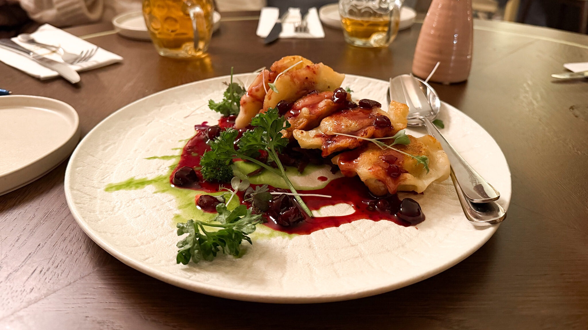 Duck pierogi served with sauce in restaurant.