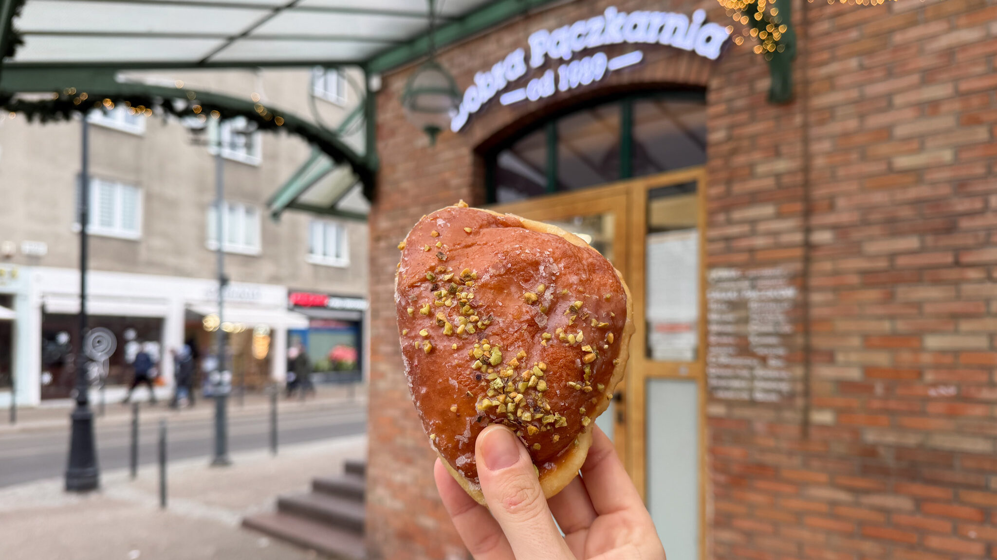 Pistachio Polish donut in front of bakery. 