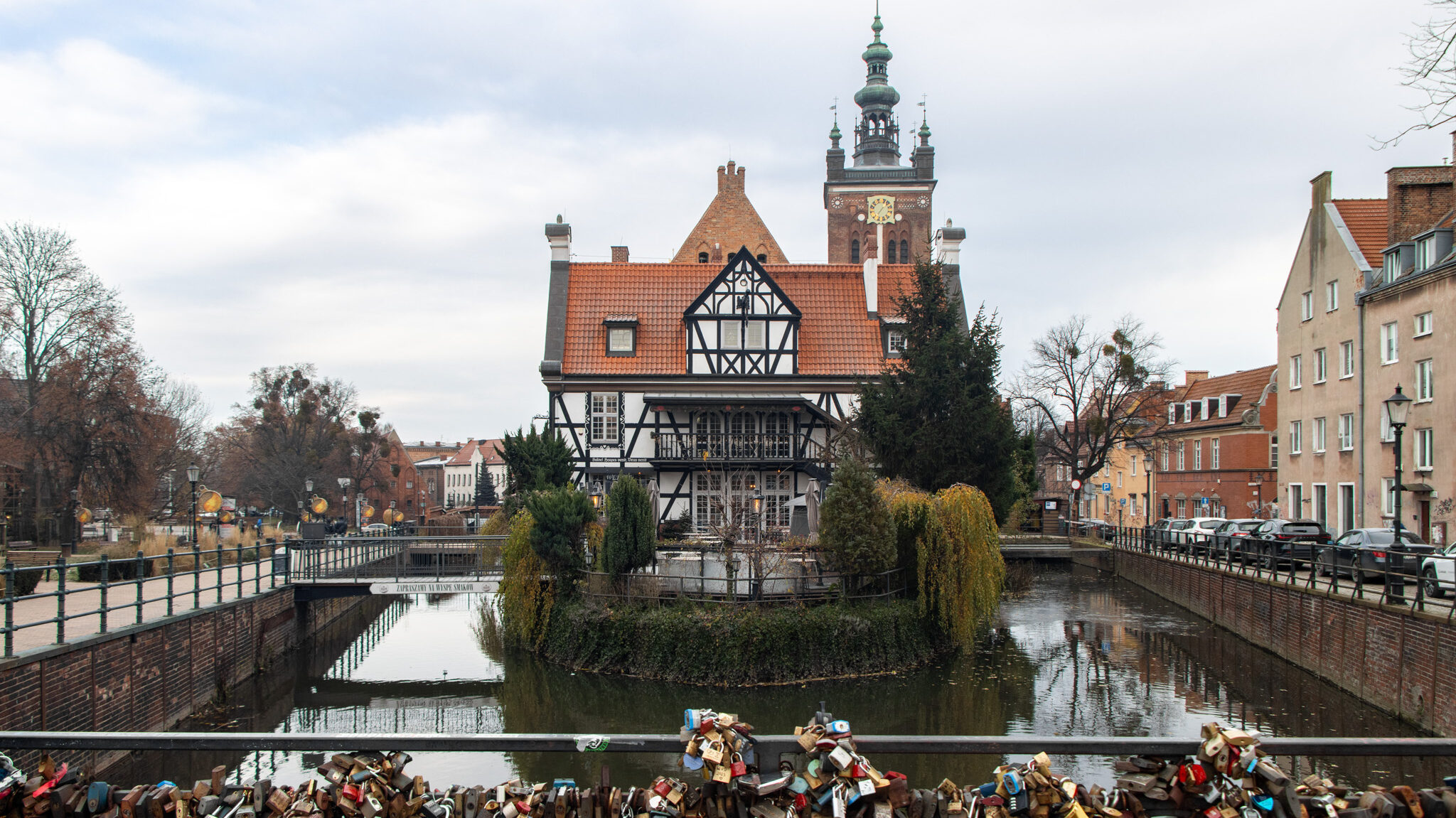 Bridge in Gdansk with locks attached along river.