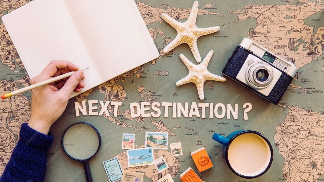 AI Travel | Krista the Explorer Flat lay of person writing in notebook on top of map.